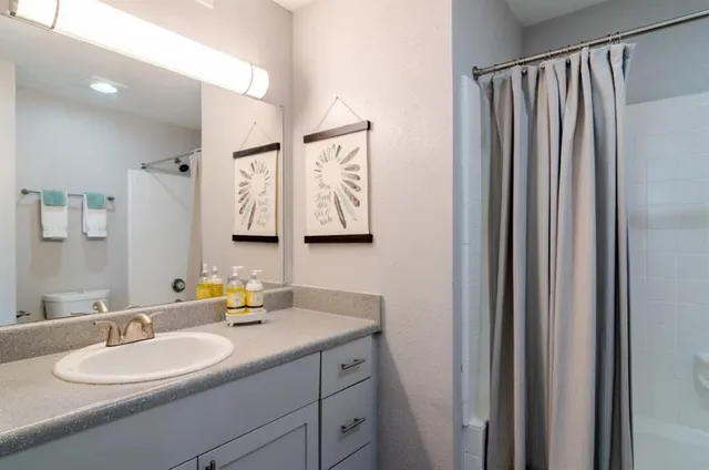 a bathroom with a double vanity sink and a mirror