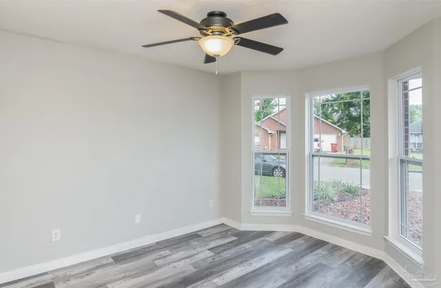 a view of room with window and ceiling fan