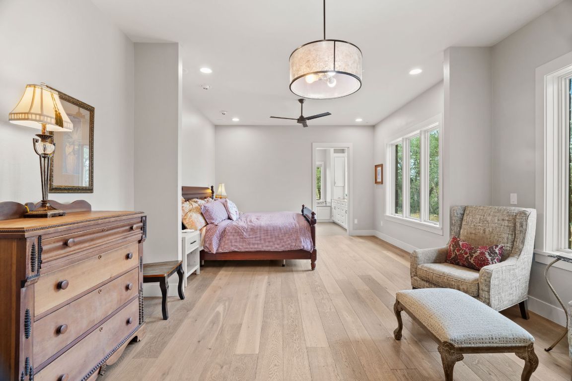 11400 Crumley Ranch Road Austin, TX 78738 - Photo 16 of 39 a bedroom with furniture and wooden floor