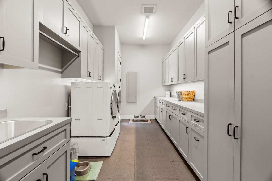 11400 Crumley Ranch Road Austin, TX 78738 - Photo 22 of 39 a kitchen with white cabinets and white appliances