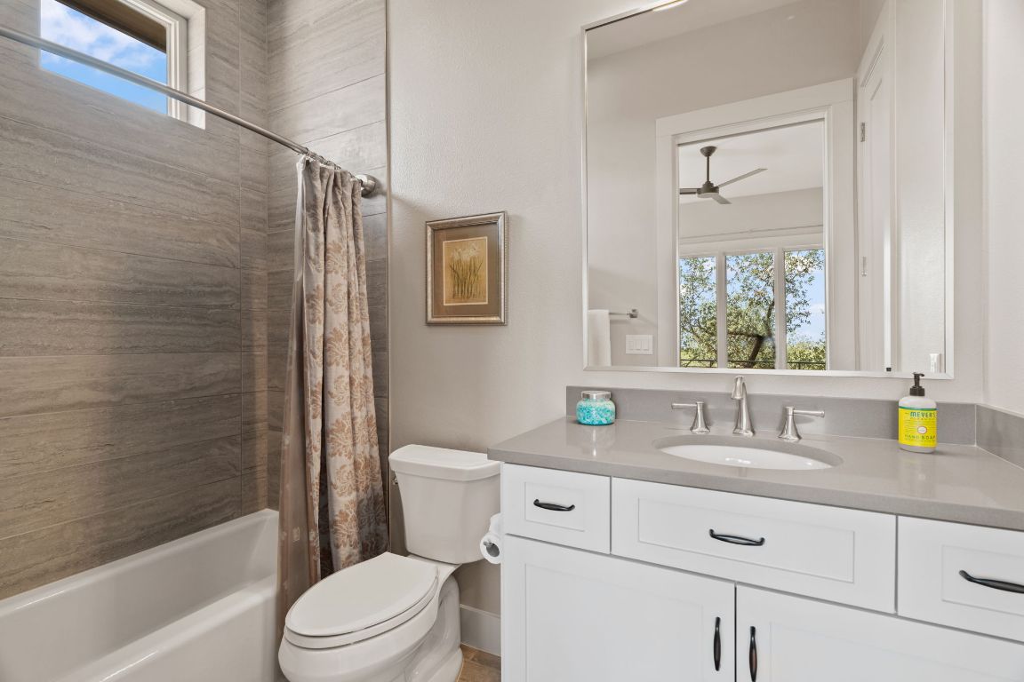 11400 Crumley Ranch Road Austin, TX 78738 - Photo 26 of 39 a bathroom with a granite countertop sink toilet and shower
