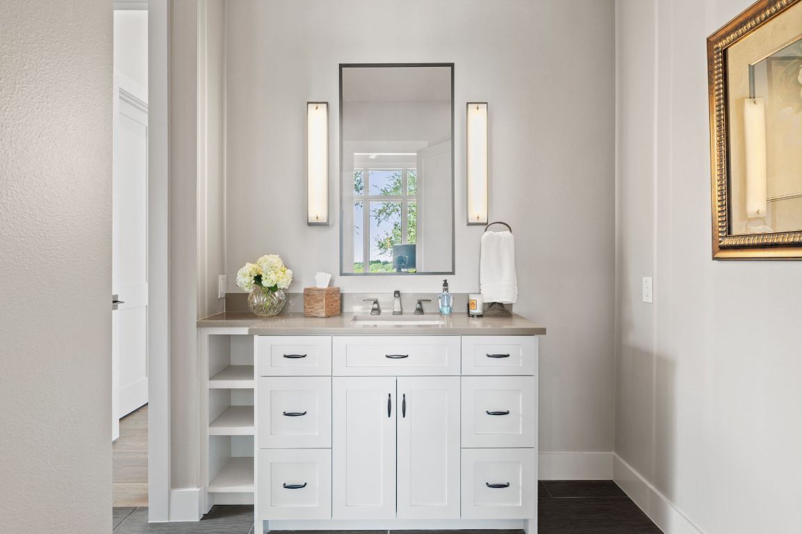 11400 Crumley Ranch Road Austin, TX 78738 - Photo 29 of 39 a bathroom with a sink vanity granite and a mirror