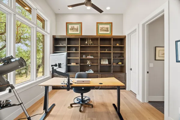a living room with furniture pool table and a large window
