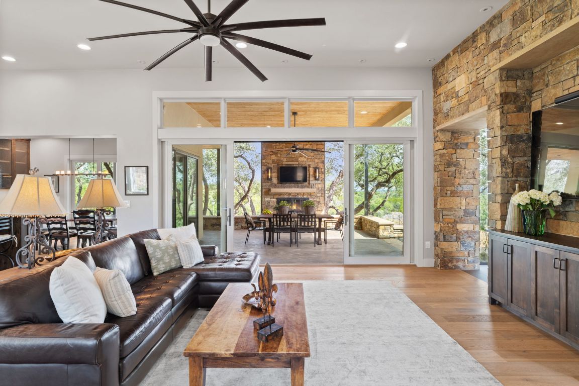 11400 Crumley Ranch Road Austin, TX 78738 - Photo 10 of 39 a living room with furniture large window and wooden floor