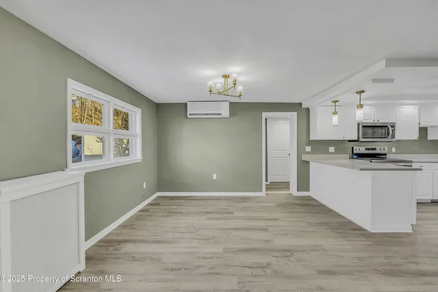 a kitchen with a sink cabinets and wooden floor