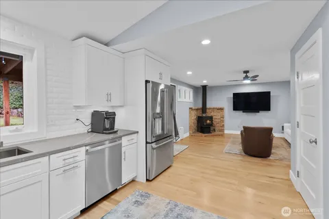 a kitchen with stainless steel appliances white cabinets and a refrigerator