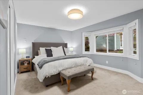a spacious bedroom with a bed and a large window