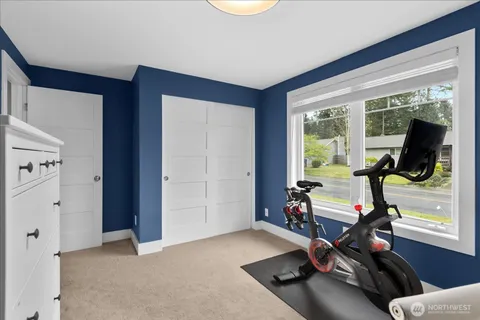 a room with gym equipment and a large window