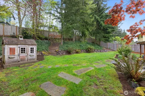 a view of backyard of house with green space