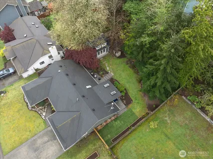 an aerial view of a house with a yard