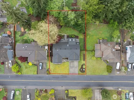 an aerial view of residential houses with yard