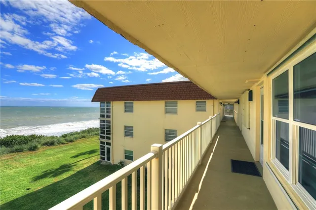 a view of a ocean with a building in the background