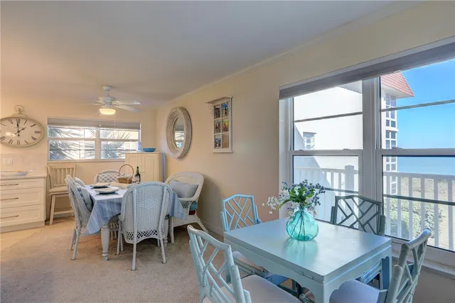 a kitchen with granite countertop white cabinets white stainless steel appliances and a window