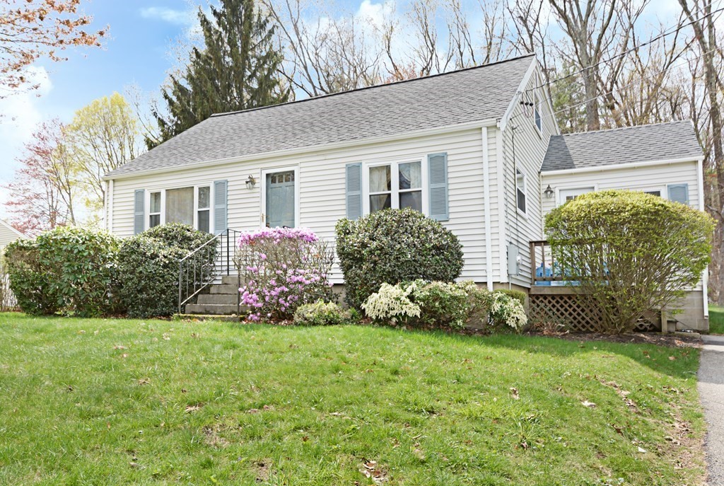 a front view of a house with a garden