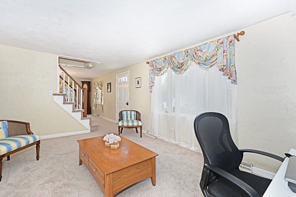 107 Causeway Street Hudson, MA 01749 - Photo 11 of 21 a living room with furniture and a wooden floor