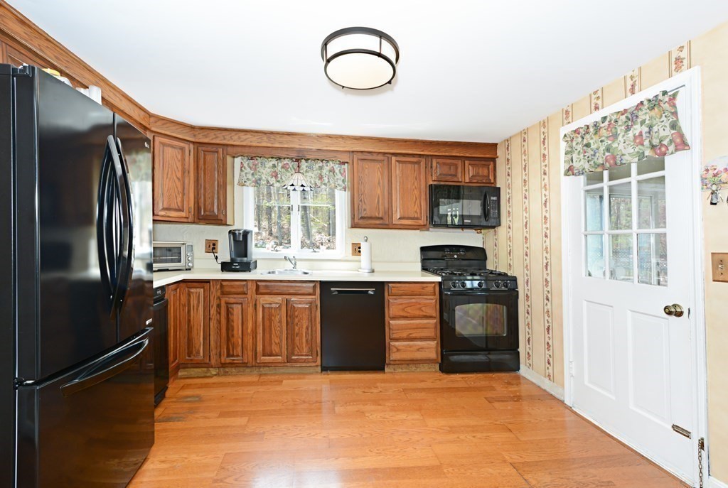 107 Causeway Street Hudson, MA 01749 - Photo 12 of 21 a kitchen with stainless steel appliances granite countertop a refrigerator sink and stove