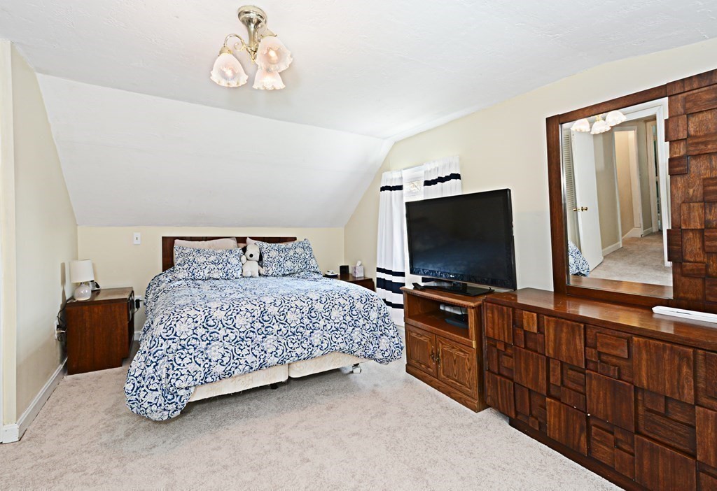 107 Causeway Street Hudson, MA 01749 - Photo 16 of 21 a bedroom with a bed and flat screen tv