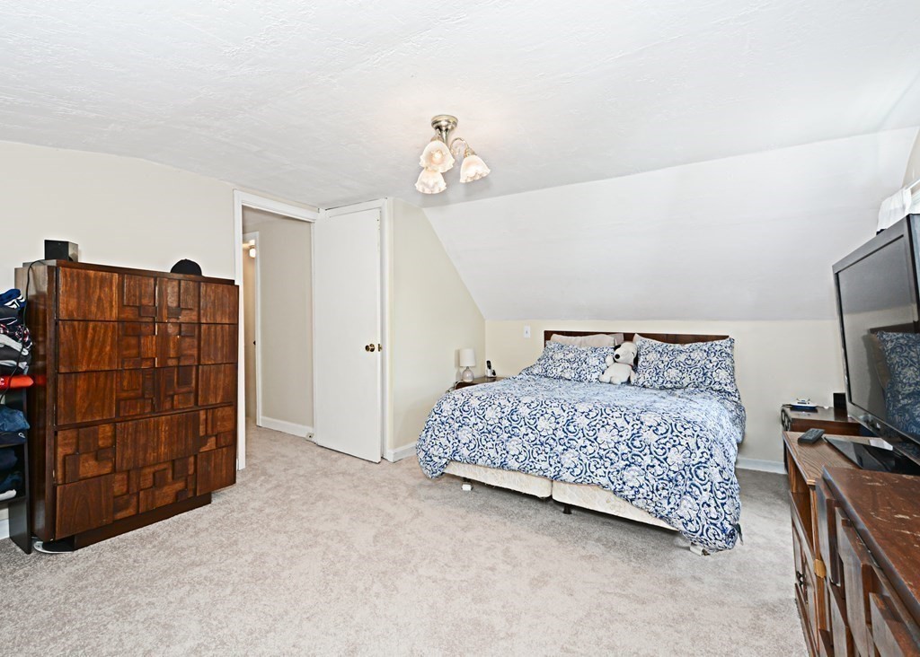 107 Causeway Street Hudson, MA 01749 - Photo 17 of 21 a bedroom with a bed and a walk in closet