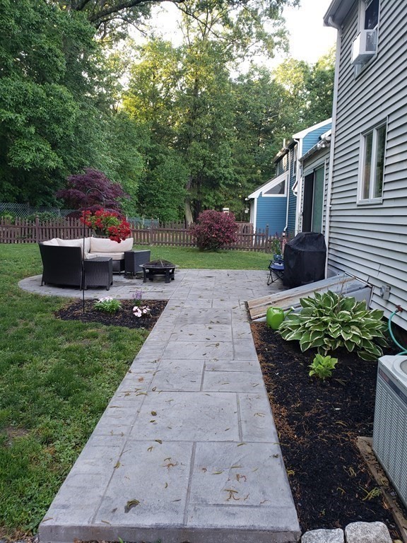 107 Causeway Street Hudson, MA 01749 - Photo 4 of 21 a front view of a house with garden