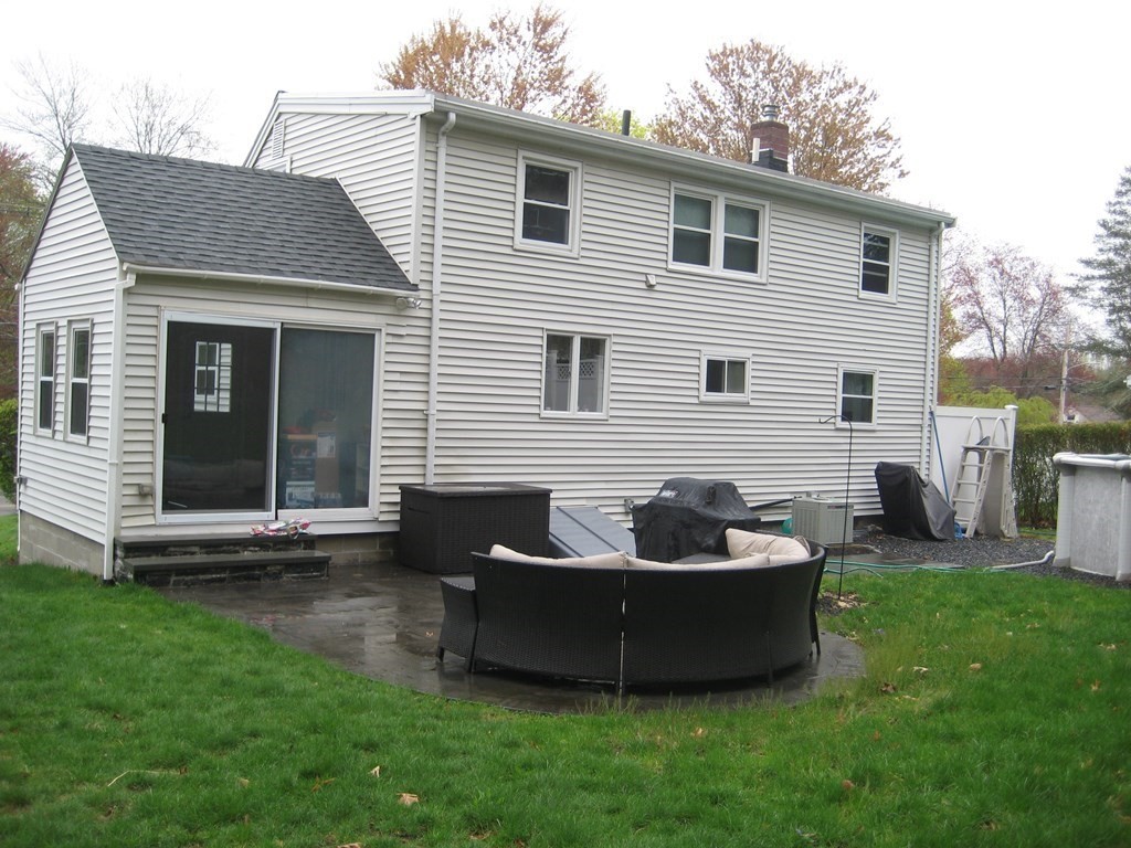 107 Causeway Street Hudson, MA 01749 - Photo 5 of 21 a view of a house with a yard and a garden
