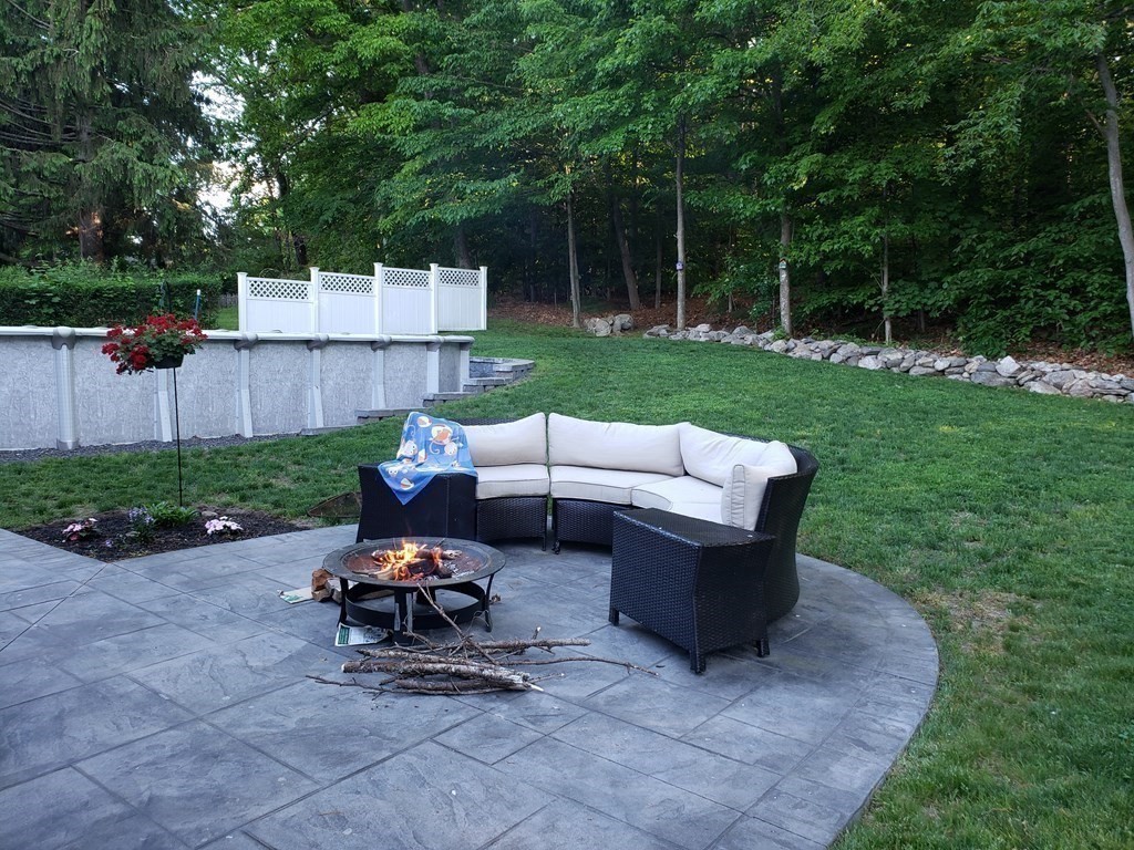 107 Causeway Street Hudson, MA 01749 - Photo 6 of 21 a view of a patio with a table and chairs
