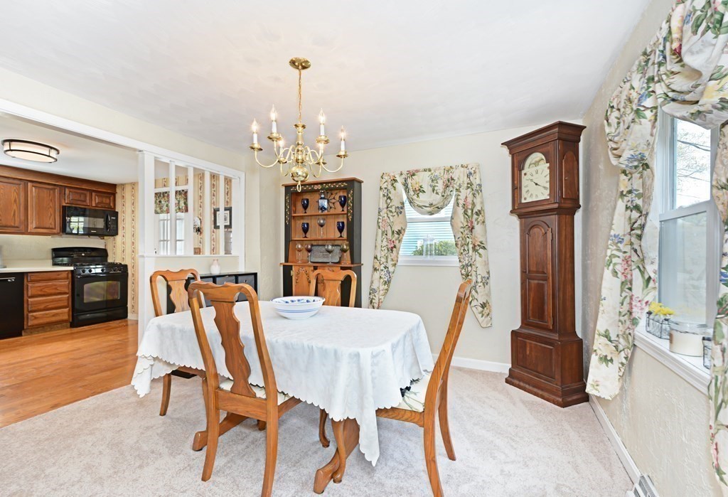 107 Causeway Street Hudson, MA 01749 - Photo 8 of 21 a view of a dining room with furniture and chandelier