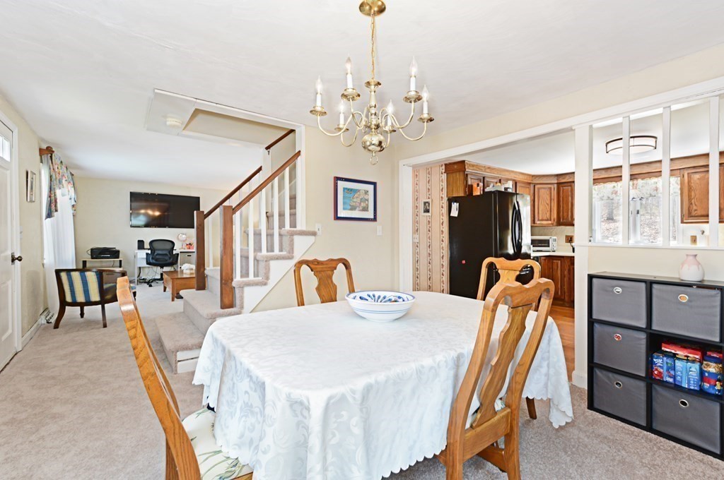 107 Causeway Street Hudson, MA 01749 - Photo 9 of 21 a view of a dining room with furniture and a chandelier