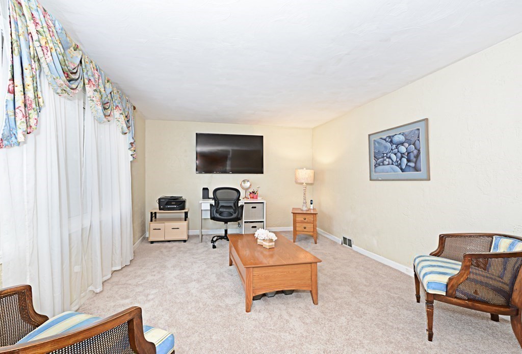 107 Causeway Street Hudson, MA 01749 - Photo 10 of 21 a living room with furniture and a flat screen tv