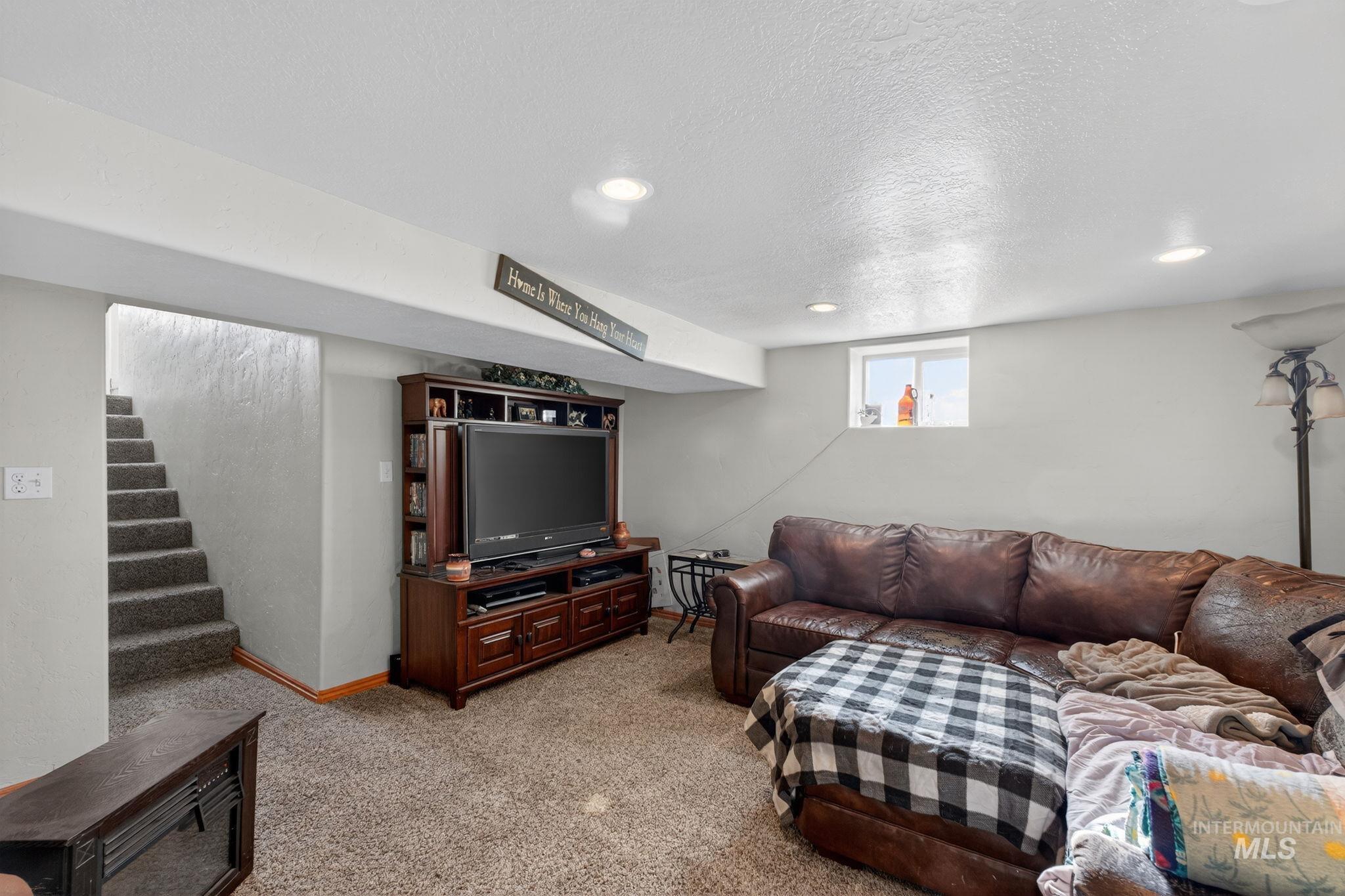 49 South 4th Street West Preston, ID 83263 - Photo 12 of 48 Carpeted living area with a textured ceiling, stairway, and recessed lighting