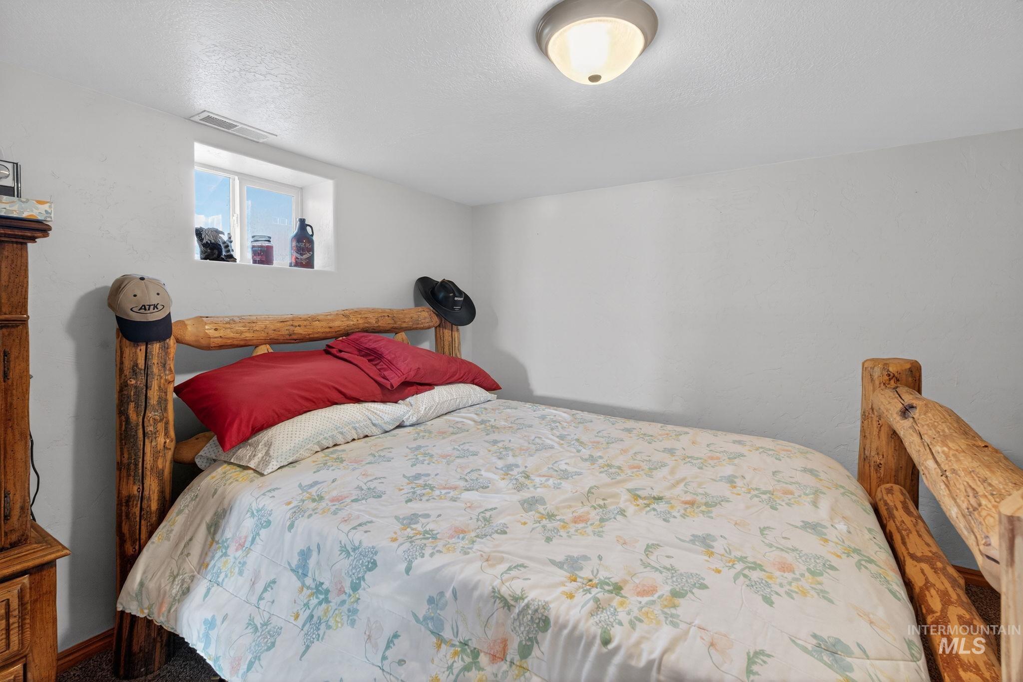 49 South 4th Street West Preston, ID 83263 - Photo 14 of 48 Carpeted bedroom with a textured ceiling