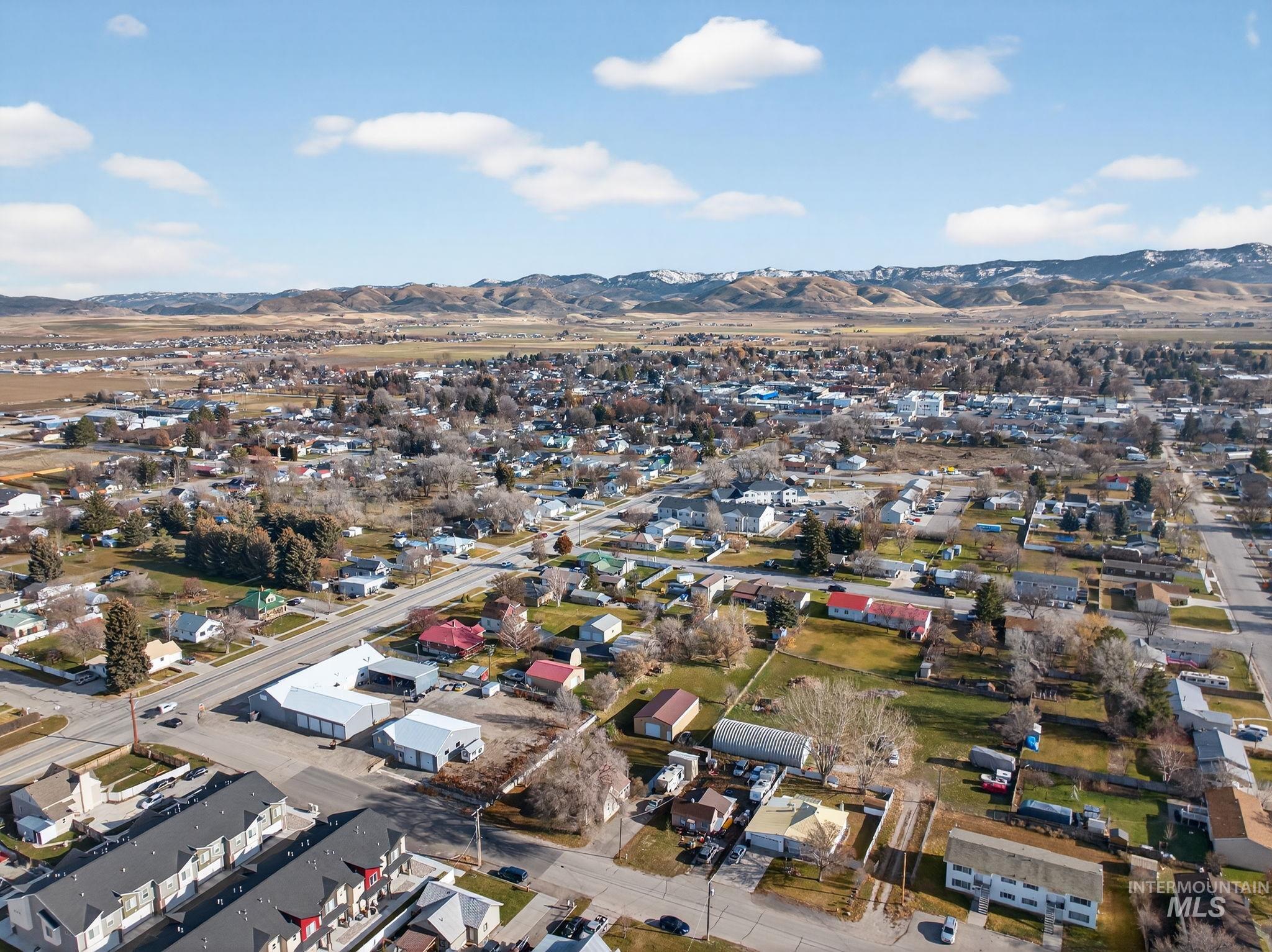 49 South 4th Street West Preston, ID 83263 - Photo 43 of 48 Aerial view of property and surrounding area featuring a mountain backdrop and nearby suburban area