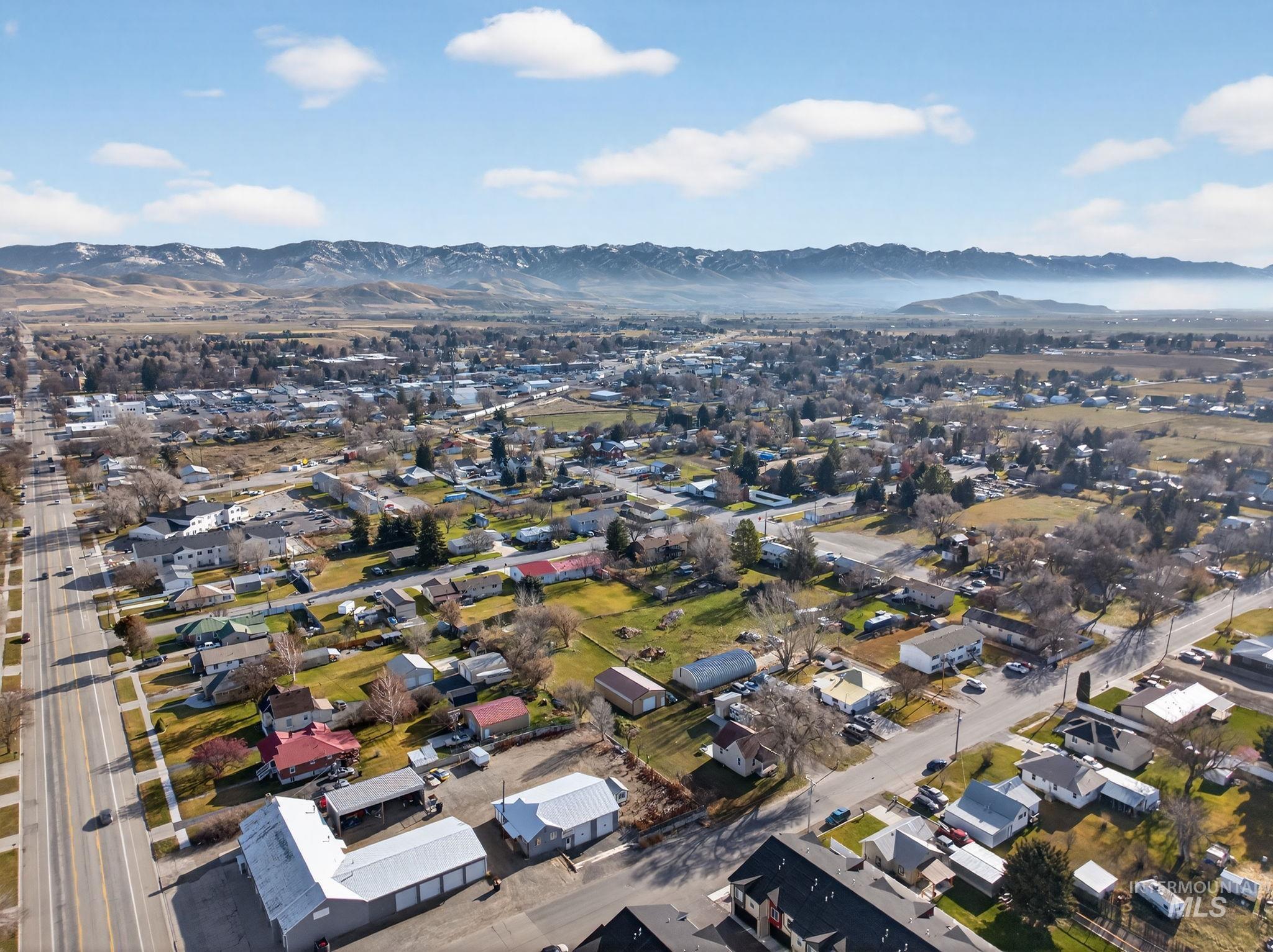 49 South 4th Street West Preston, ID 83263 - Photo 44 of 48 Aerial overview of property's location featuring a mountain backdrop and nearby suburban area