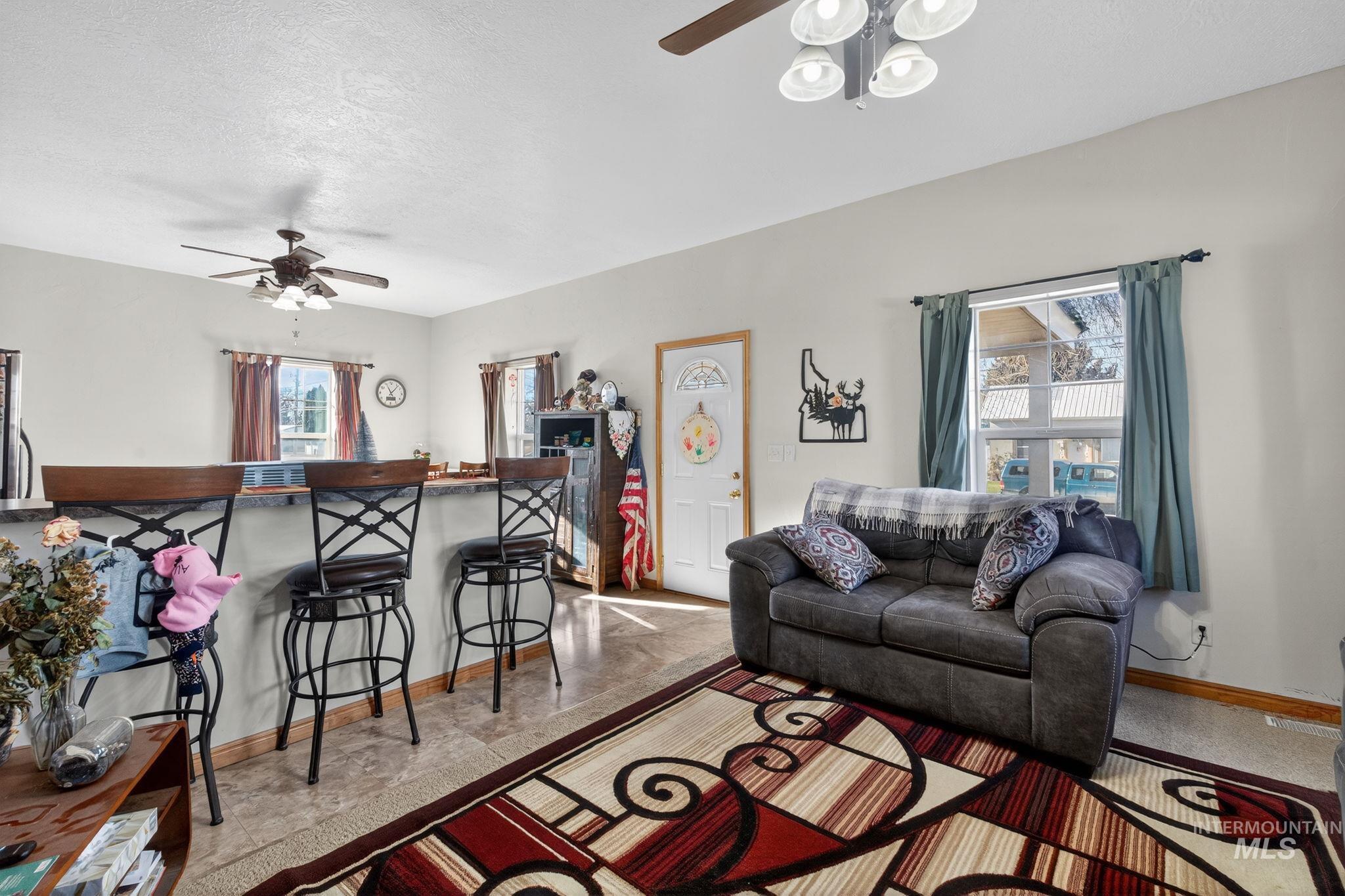 49 South 4th Street West Preston, ID 83263 - Photo 6 of 48 Living area featuring a ceiling fan and a textured ceiling