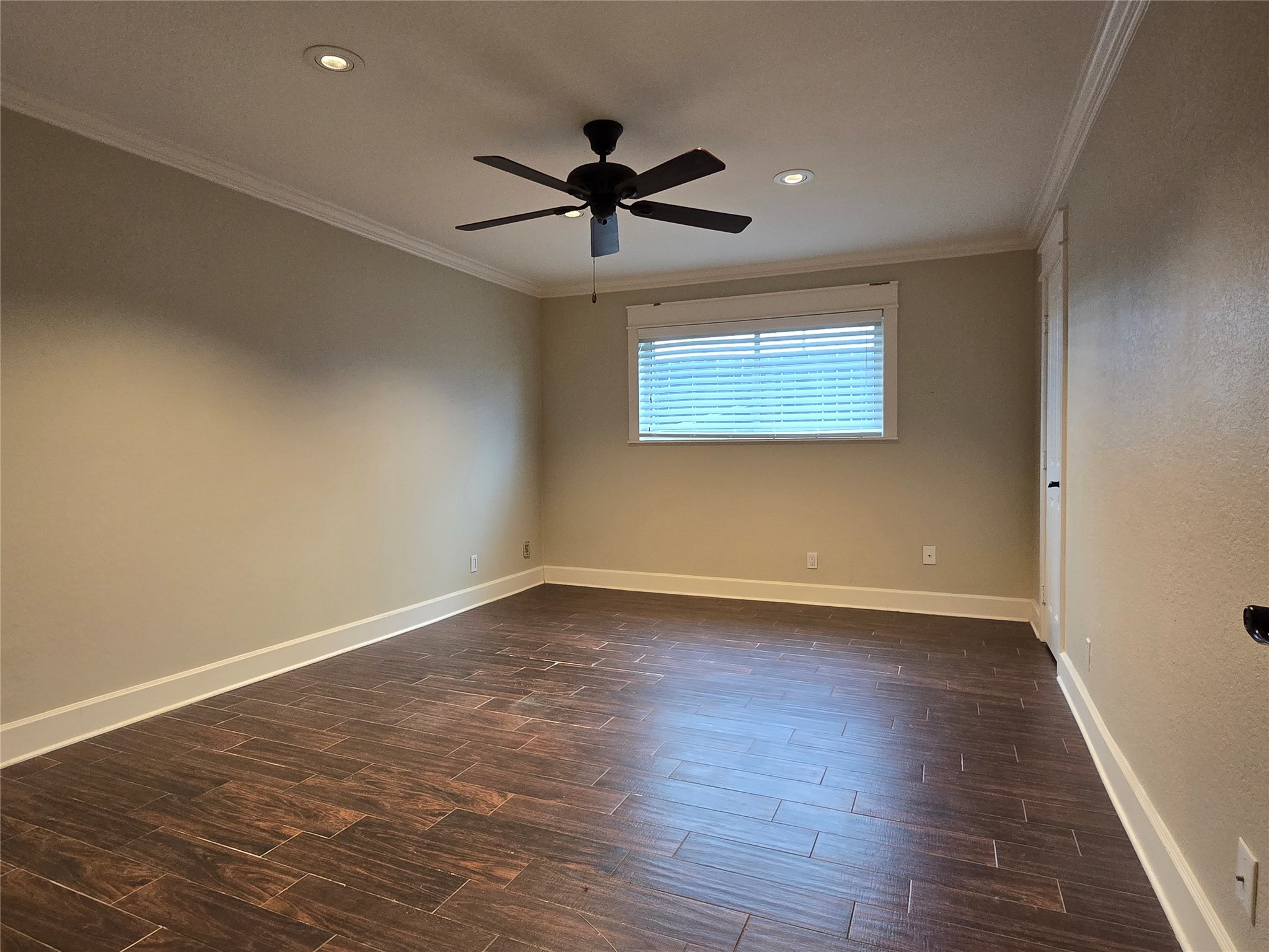 11550 Chimney Rock Road, Unit 312 Houston, TX 77035 - Photo 12 of 18 a view of an empty room with wooden floor and a window