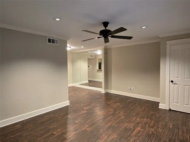 a view of an empty room and wooden floor