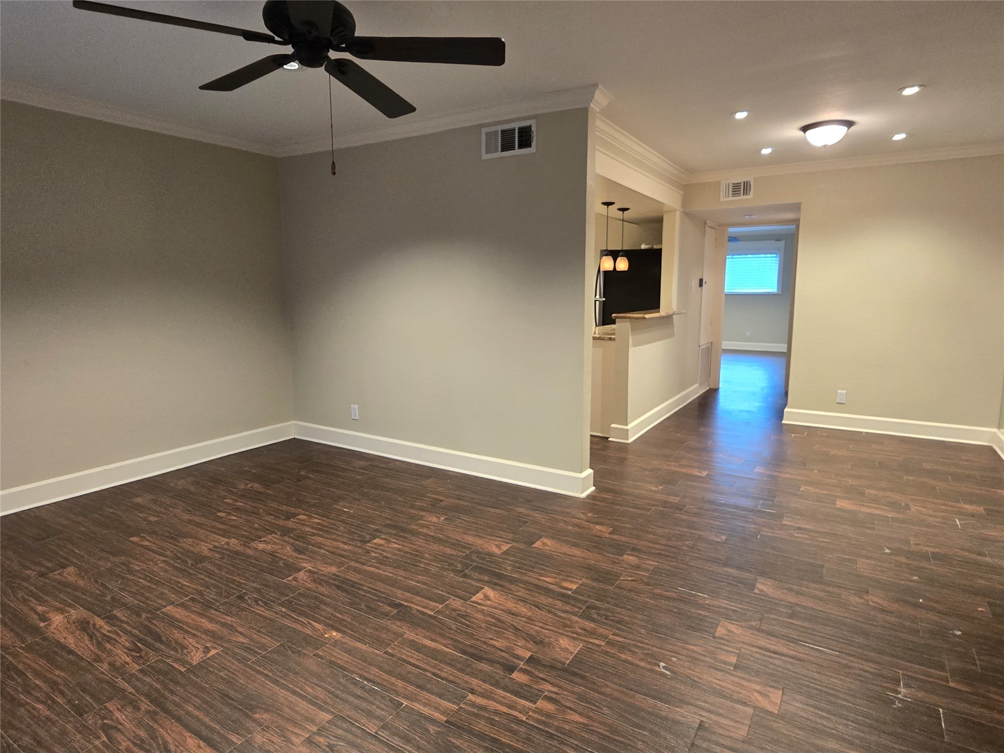 11550 Chimney Rock Road, Unit 312 Houston, TX 77035 - Photo 8 of 18 an empty room with wooden floor fan and windows