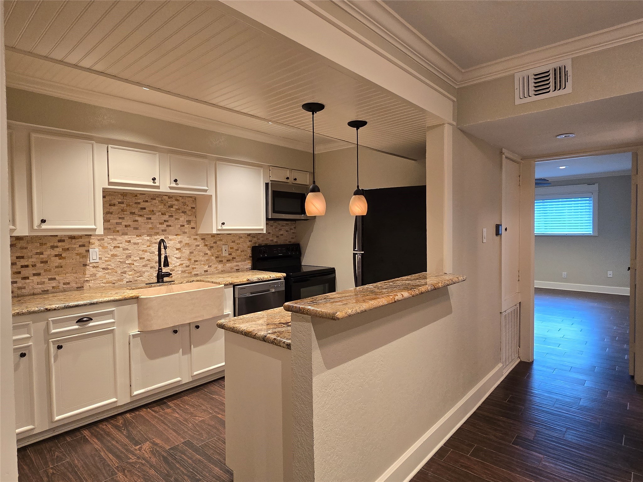 11550 Chimney Rock Road, Unit 312 Houston, TX 77035 - Photo 9 of 18 a kitchen with sink cabinets and wooden floor