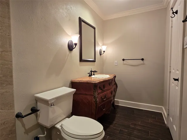 a bathroom with a toilet a sink and mirror