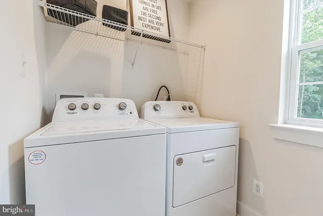a kitchen with stainless steel appliances white cabinets and a sink