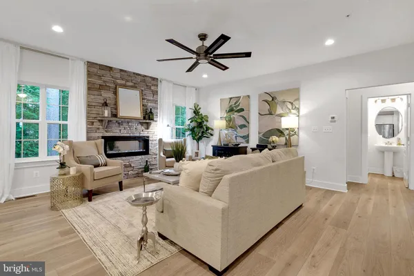 a kitchen that has a sink a oven and a clock on the wall