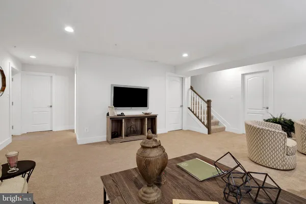 a bedroom with a bed and a lamp on dresser