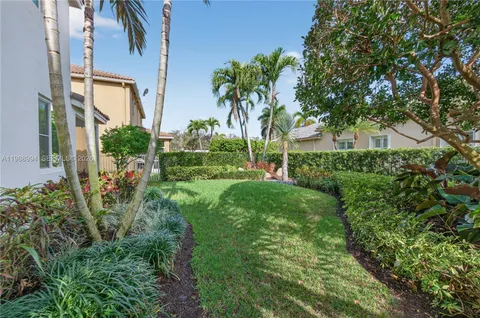 a view of a house with a yard and potted plants