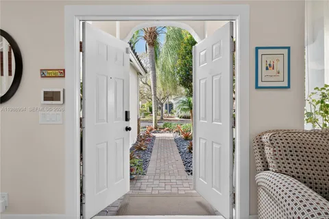 a view of a hallway with wooden floor and a dining table