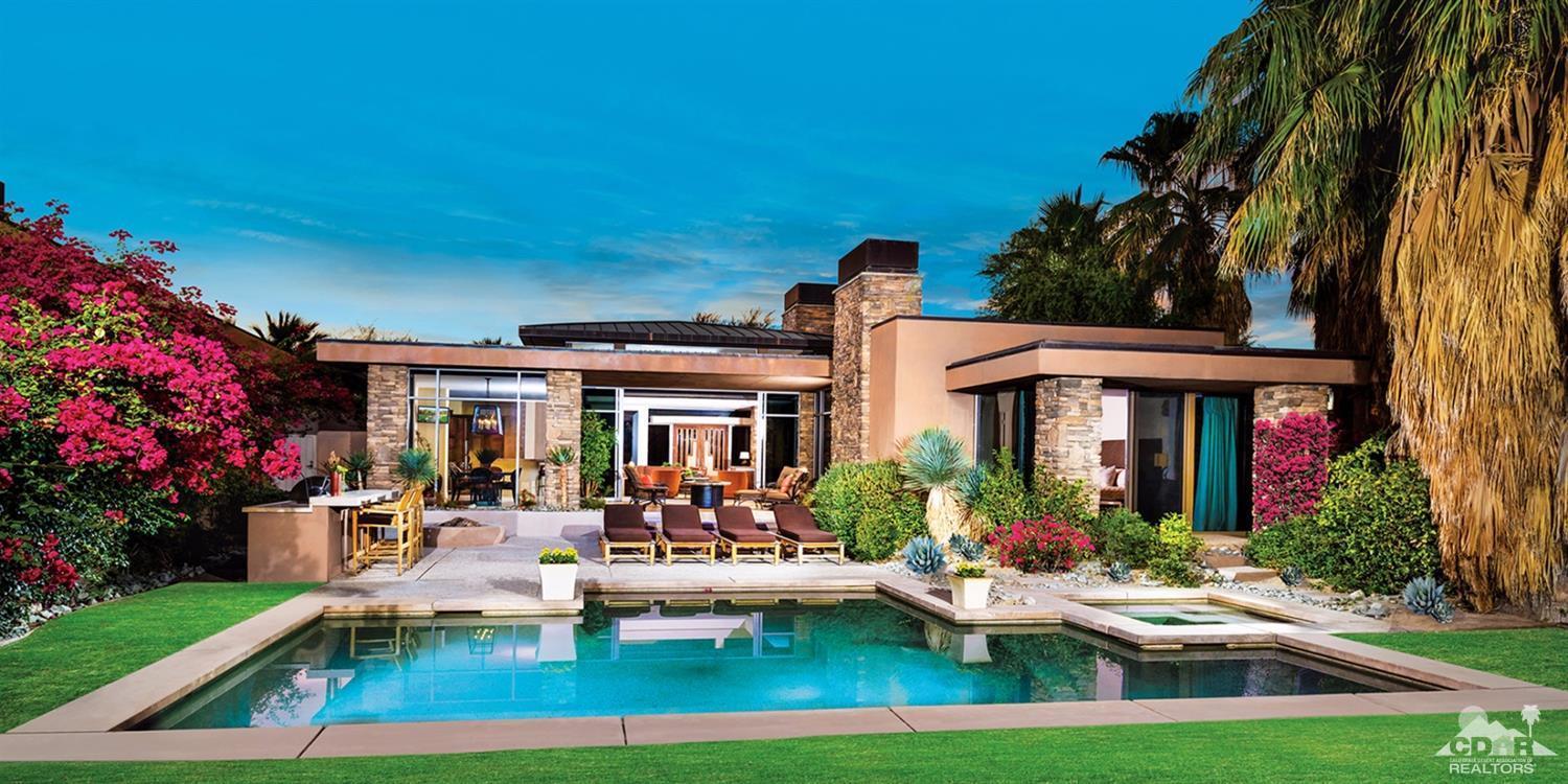 810 Shadow Vista Palm Desert, CA 92260 - Photo 1 of 11 a front view of a house with swimming pool garden and patio