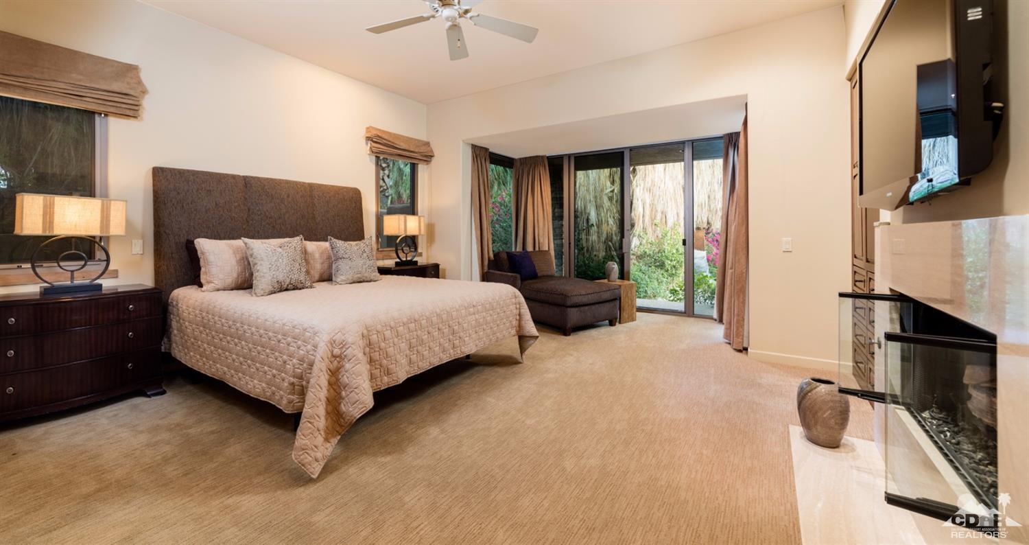 810 Shadow Vista Palm Desert, CA 92260 - Photo 7 of 11 a bedroom with a bed flat screen tv and a fireplace