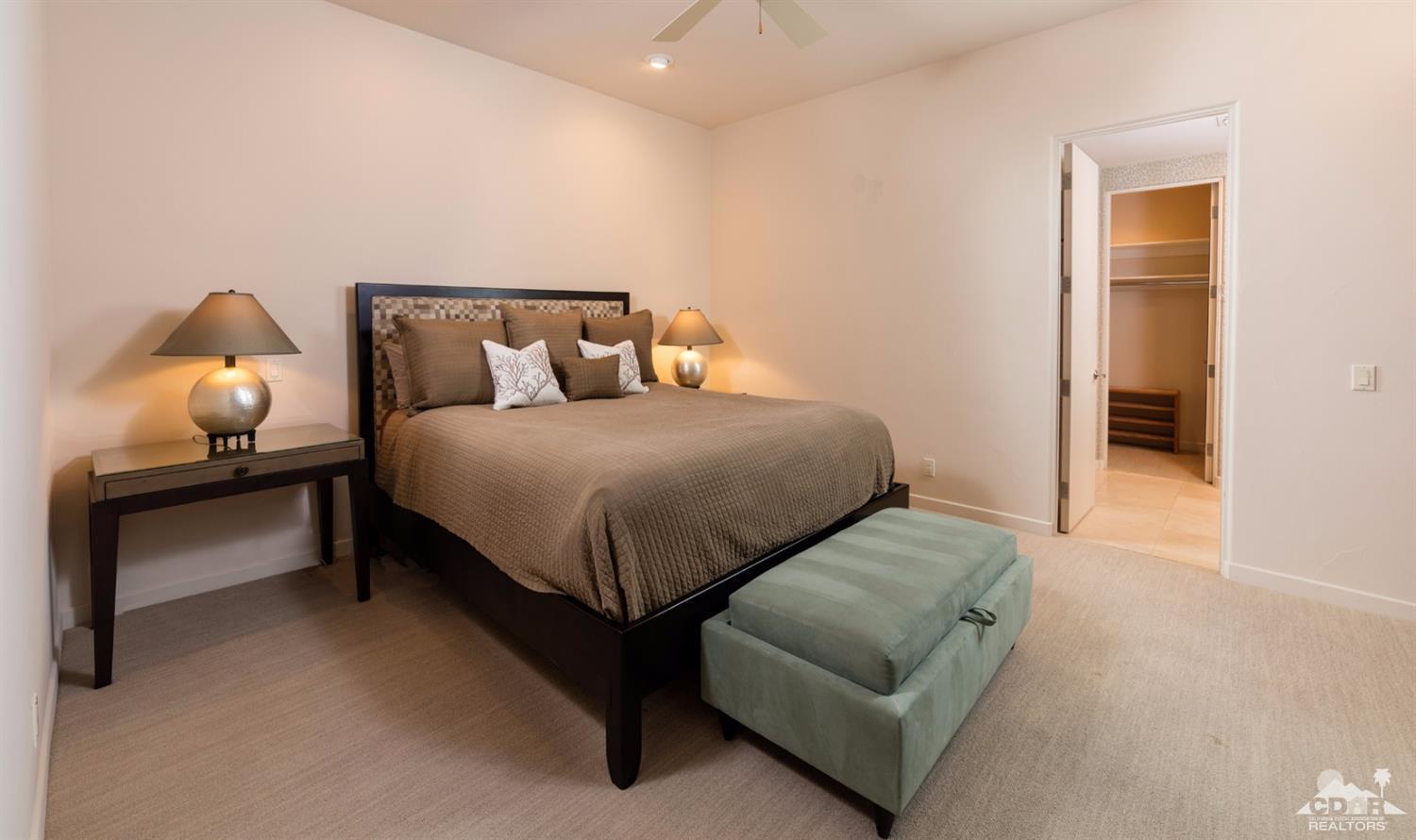 810 Shadow Vista Palm Desert, CA 92260 - Photo 10 of 11 a bedroom with a bed and a lamp