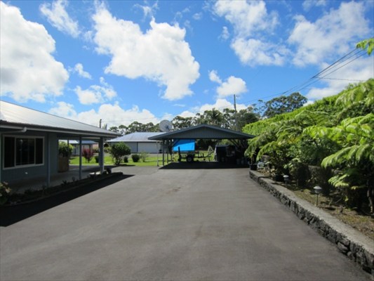 18-3976 Canney Road Mountain View, HI 96771 - Photo 24 of 25 a front view of a house with a yard and garage