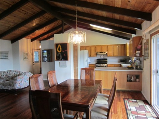 18-3976 Canney Road Mountain View, HI 96771 - Photo 6 of 25 a kitchen with stainless steel appliances granite countertop table chairs and wooden floor
