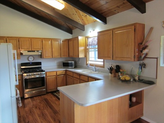 18-3976 Canney Road Mountain View, HI 96771 - Photo 7 of 25 a kitchen with a sink a stove and cabinets