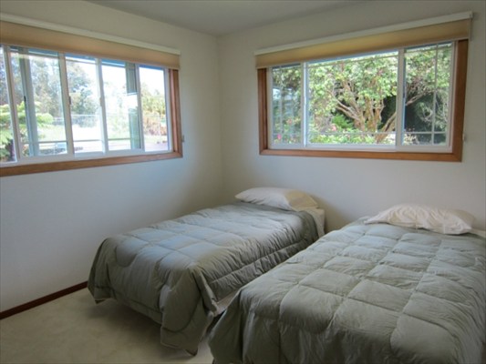 18-3976 Canney Road Mountain View, HI 96771 - Photo 10 of 25 a bed sitting in a bedroom next to a window